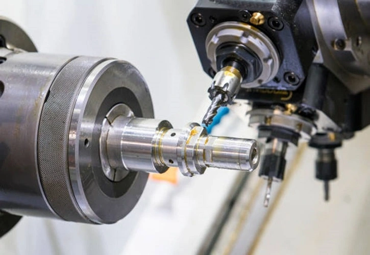 Close‑up view of CNC lathe spindle processing metal mechanical parts Close‑up view of CNC lathe spindle processing metal mechanical parts