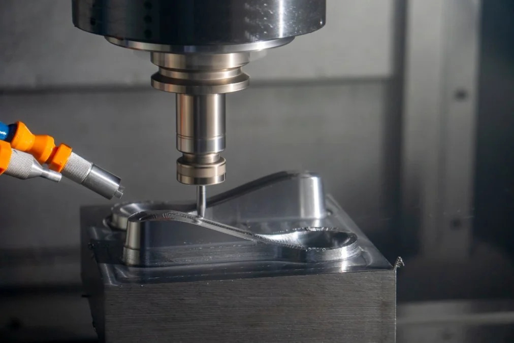 CNC milling machine cutting metal workpiece for precision prototype manufacturing