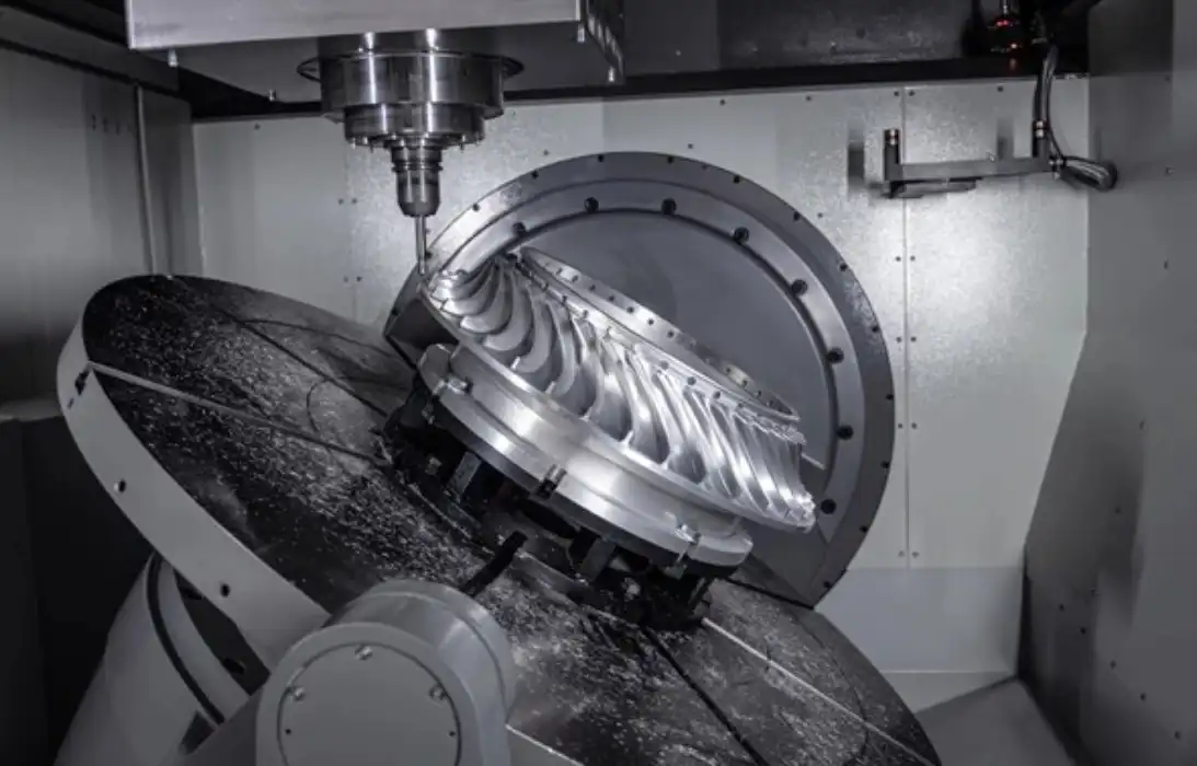 5-axis machining equipment fabricating curved aerospace turbine parts from high strength alloy