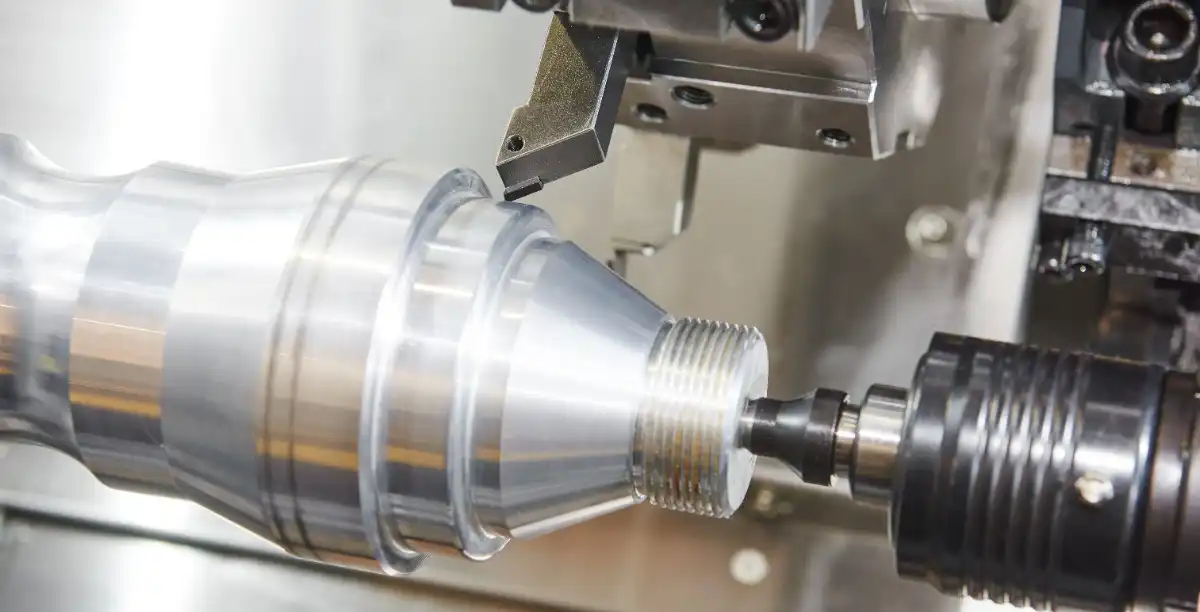Finished precision CNC turned cylindrical part on lathe spindle
