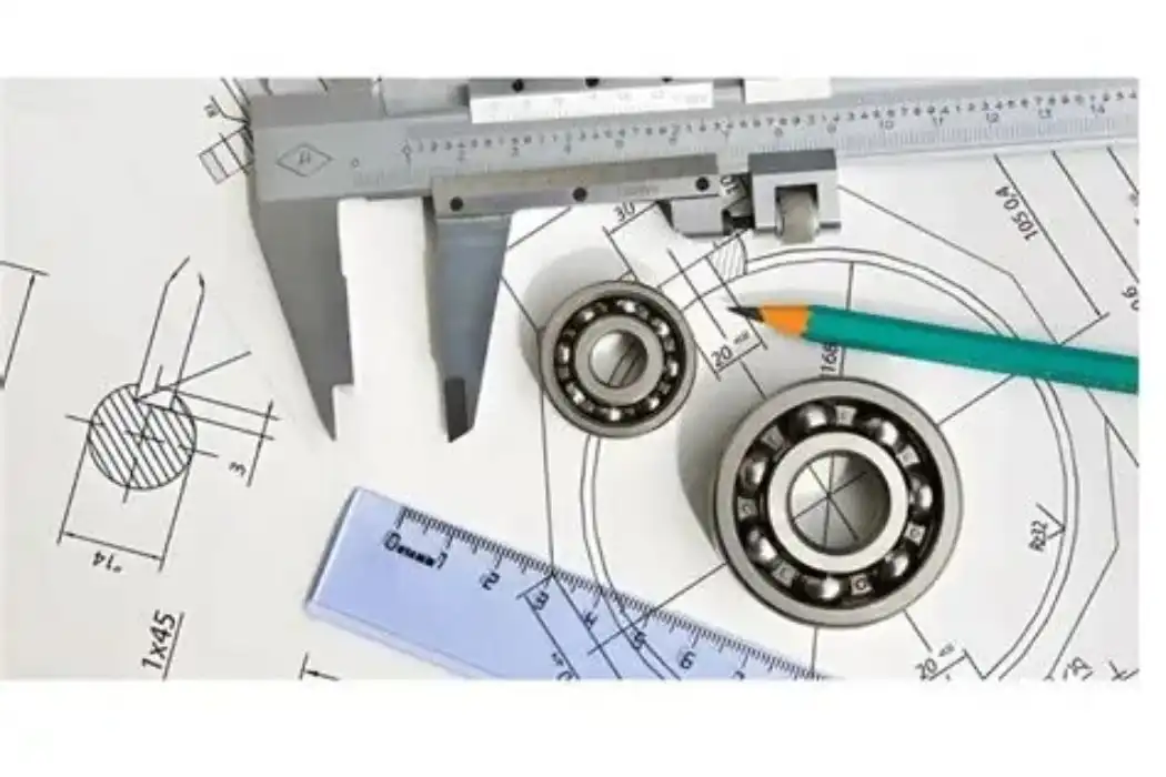 Engineer reviews GD&T engineering drawing and uses caliper to inspect machined parts