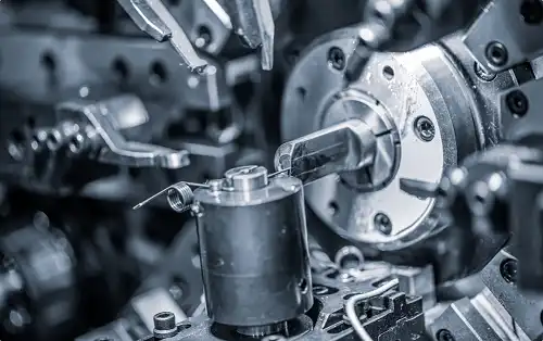 Close-up of CNC machining center cutting stainless steel workpiece with rotating tool